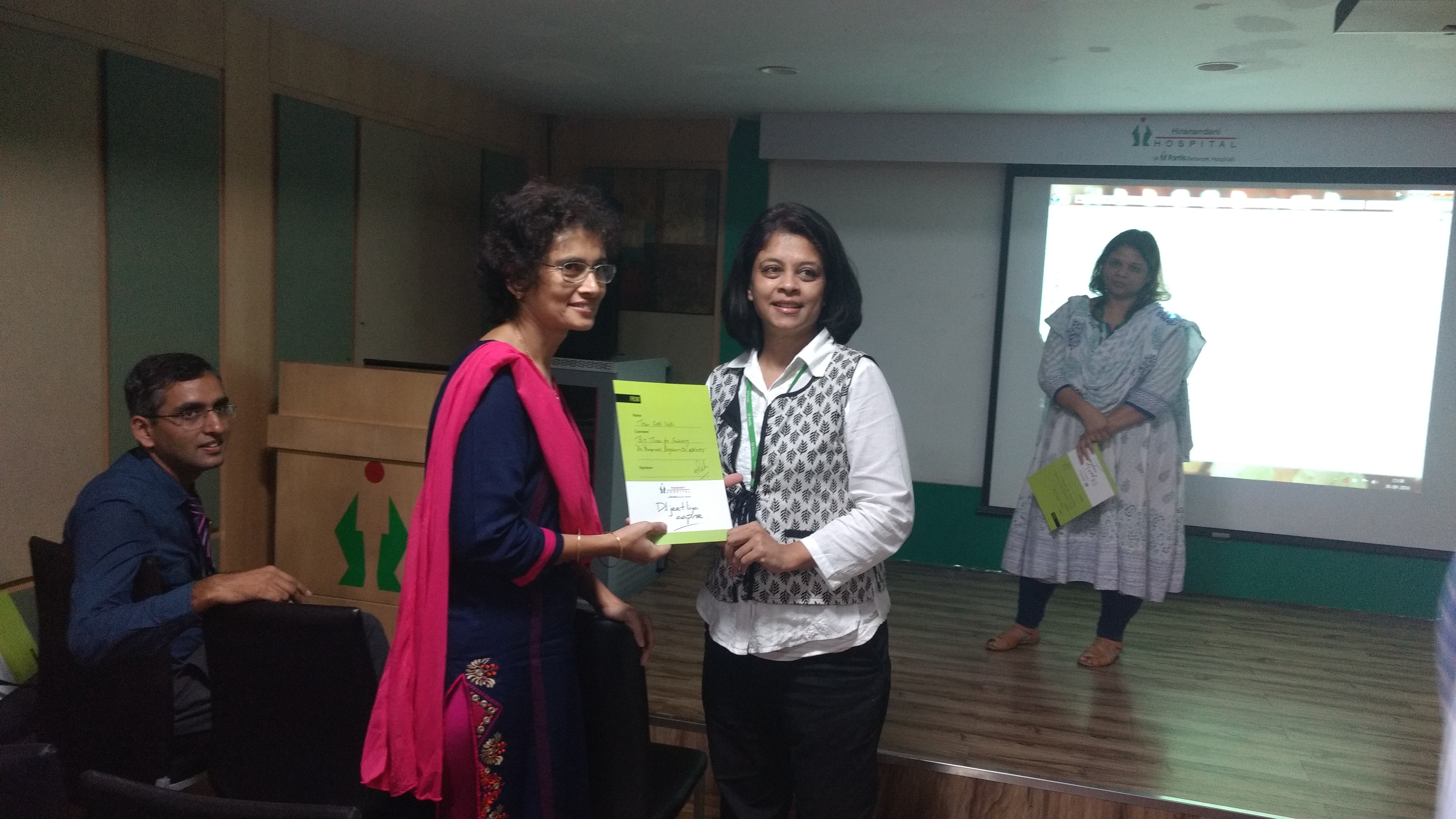The Dean of Fortis Hiranandani Hospital, Vashi presenting certificates to Pooja & Carol